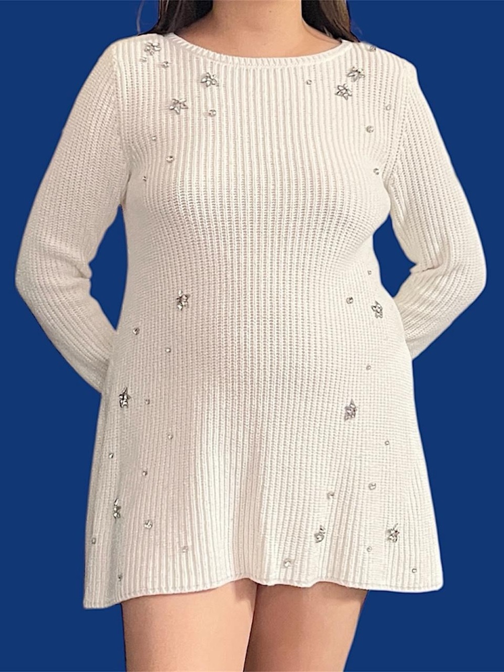 white sweater with silver star embellishments